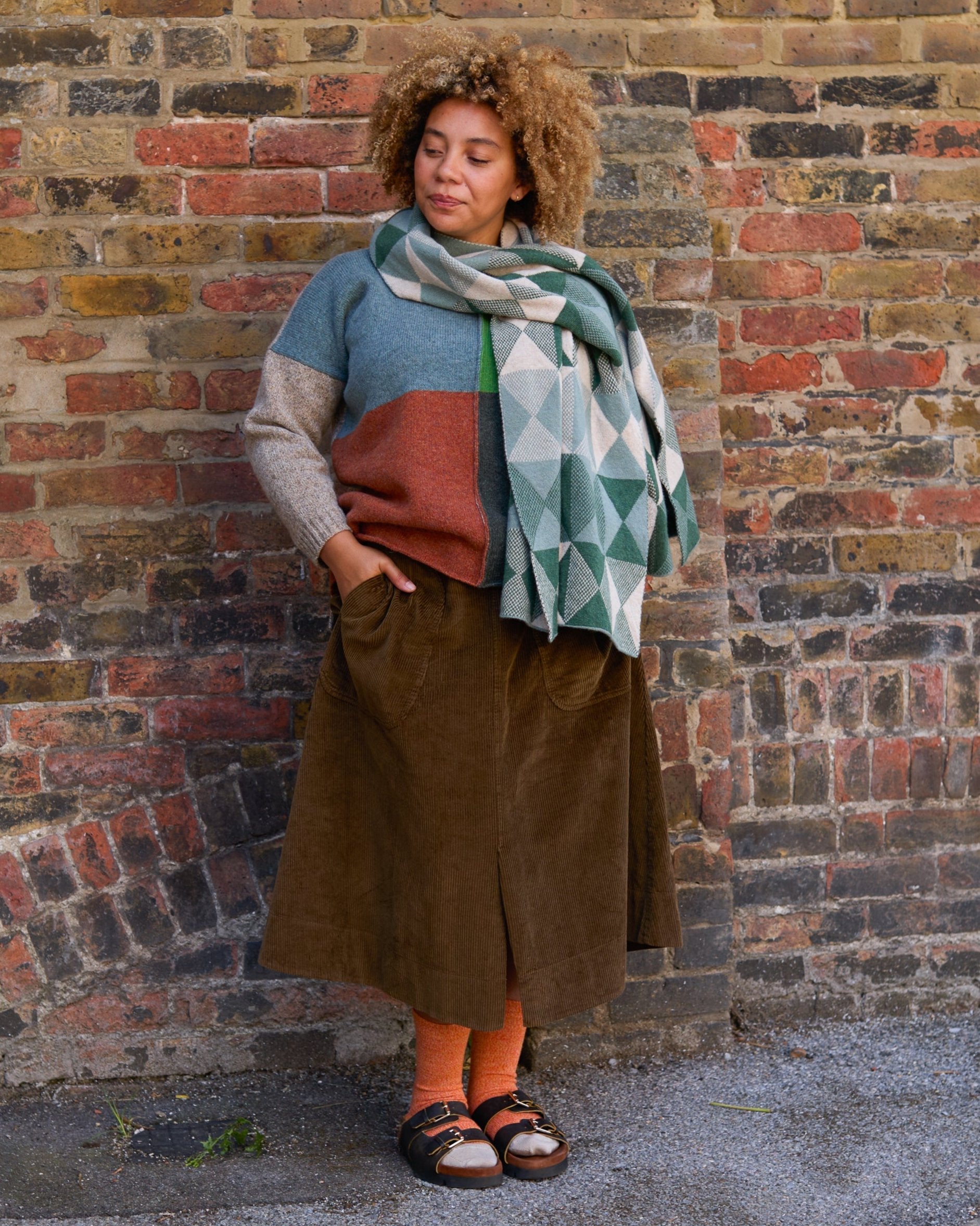 Model wears orange wool socks, with Birkenstock sandals. Knitted in soft merino wool. Designed and made in Britain.
