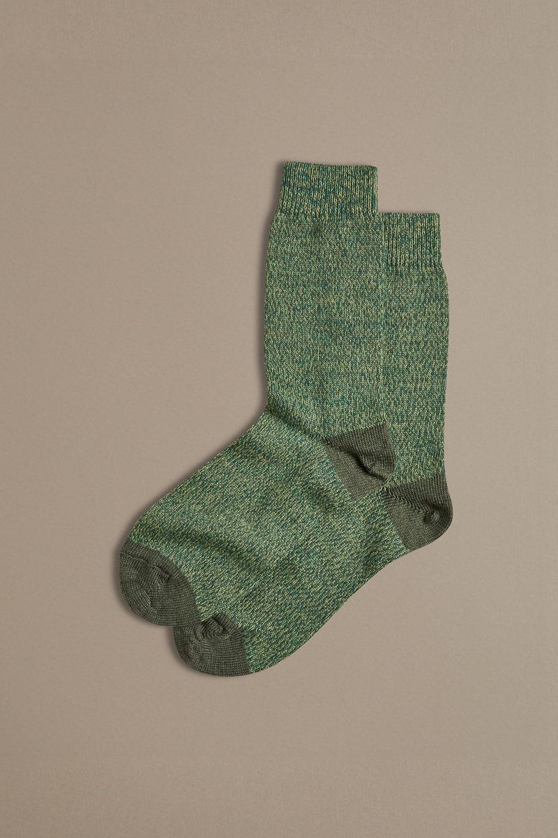 Pair of Merino wool socks in green, with a contrast toe and heel. Designed and made in the UK.