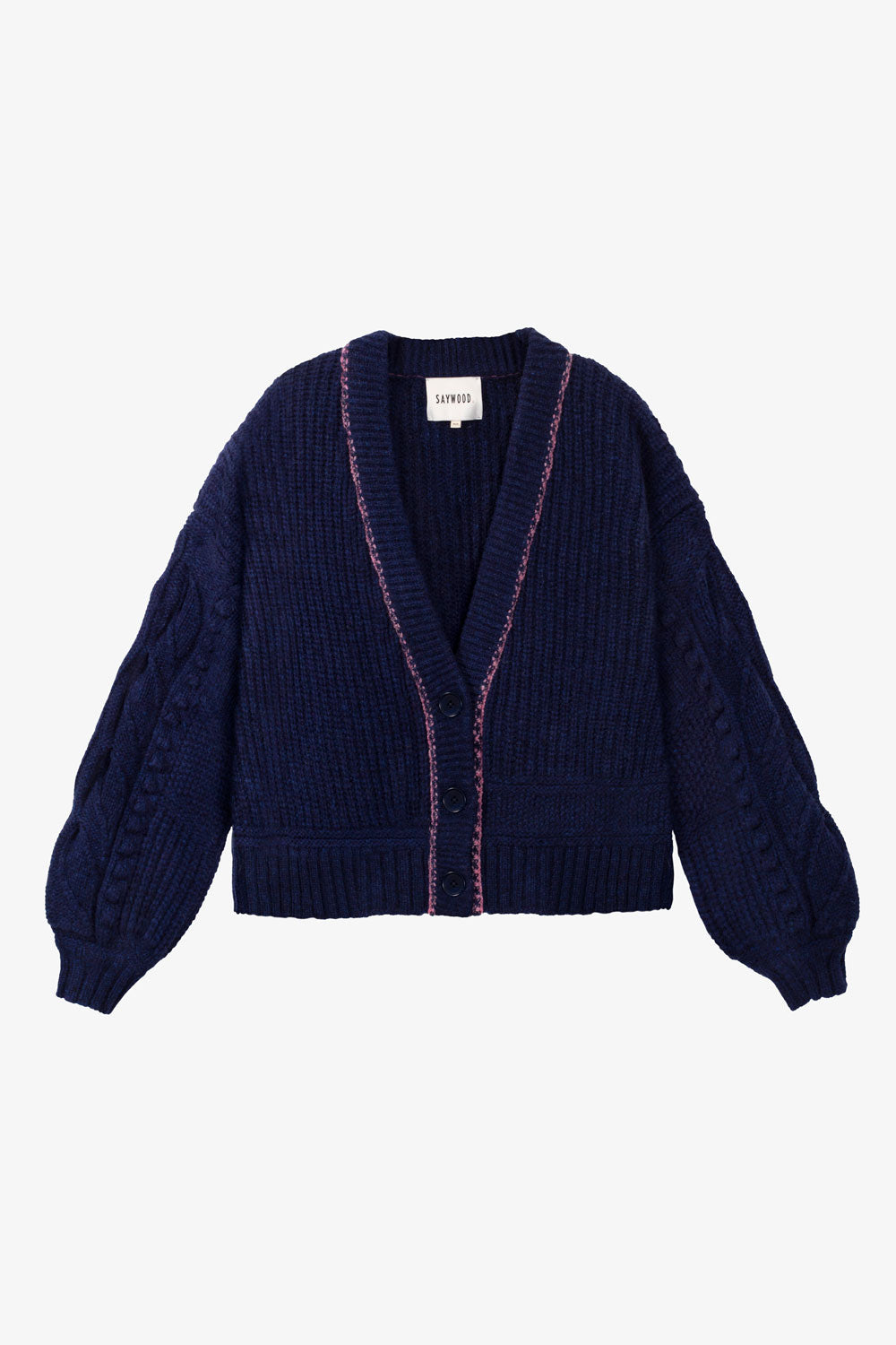 Navy blue chunky knit cardigan with pink stitching trim around the neck on a light grey background. Made in the UK.