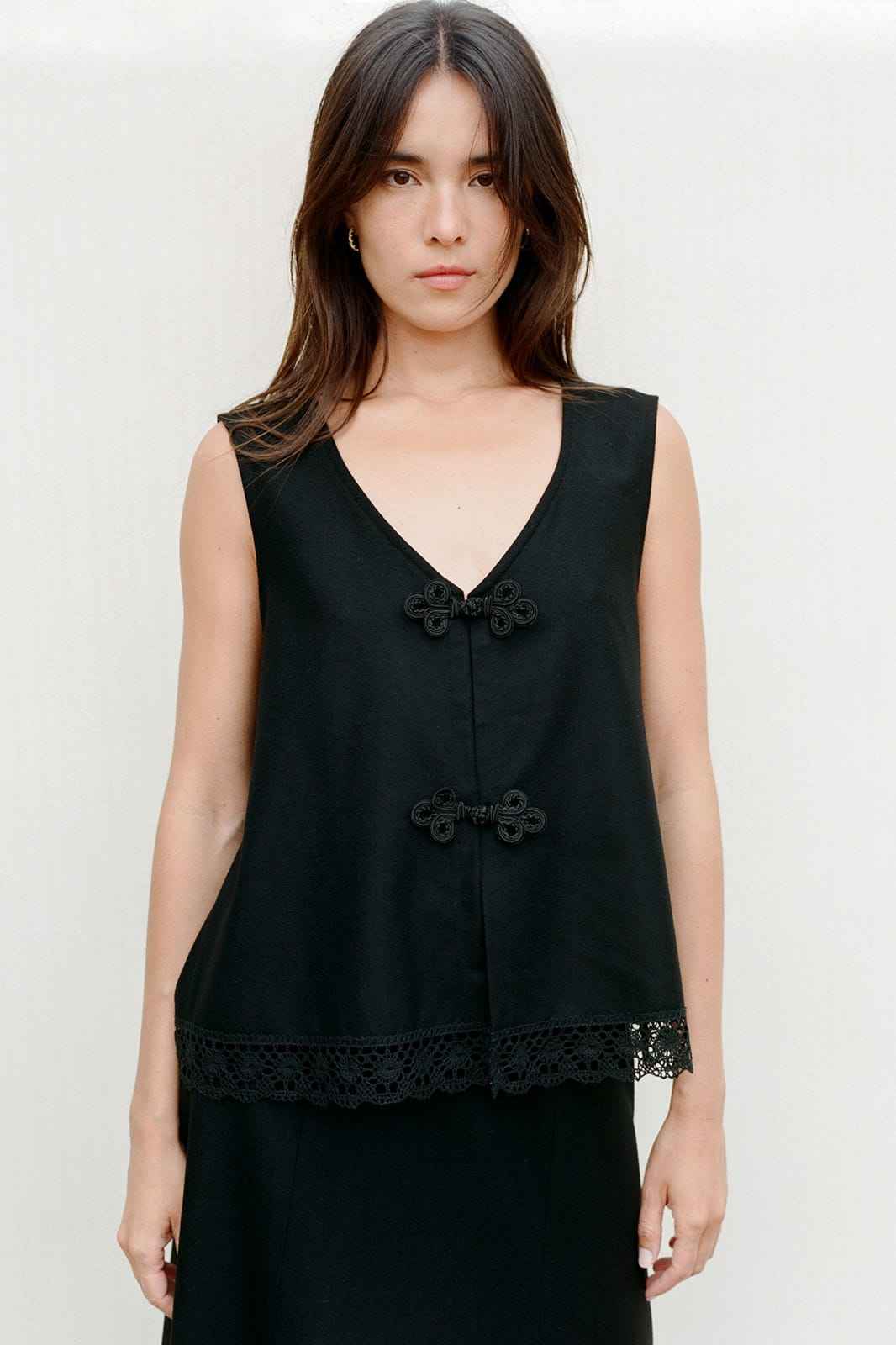 The Marie Sleeveless Wool Vest in black with lace trim