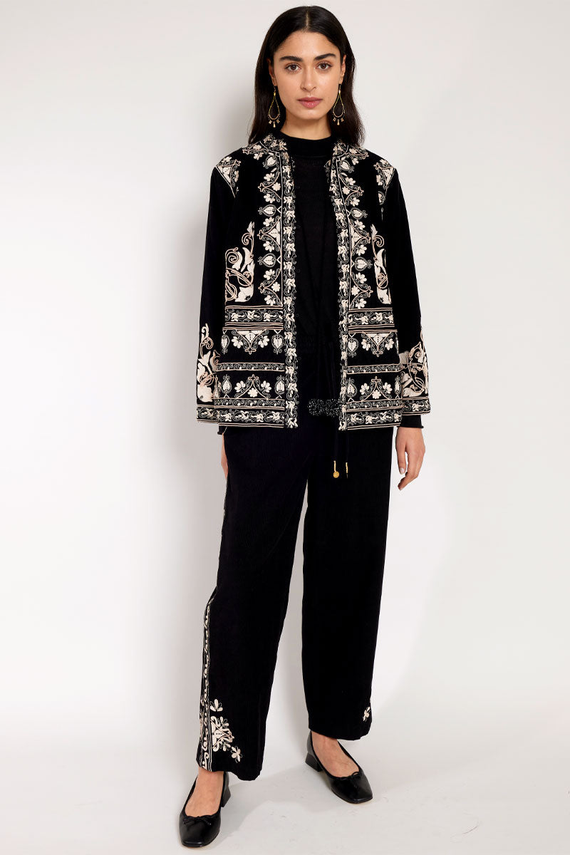 Front view of Model wearing East Eveline embroidered jacket with the East Eveline embroidered trousers