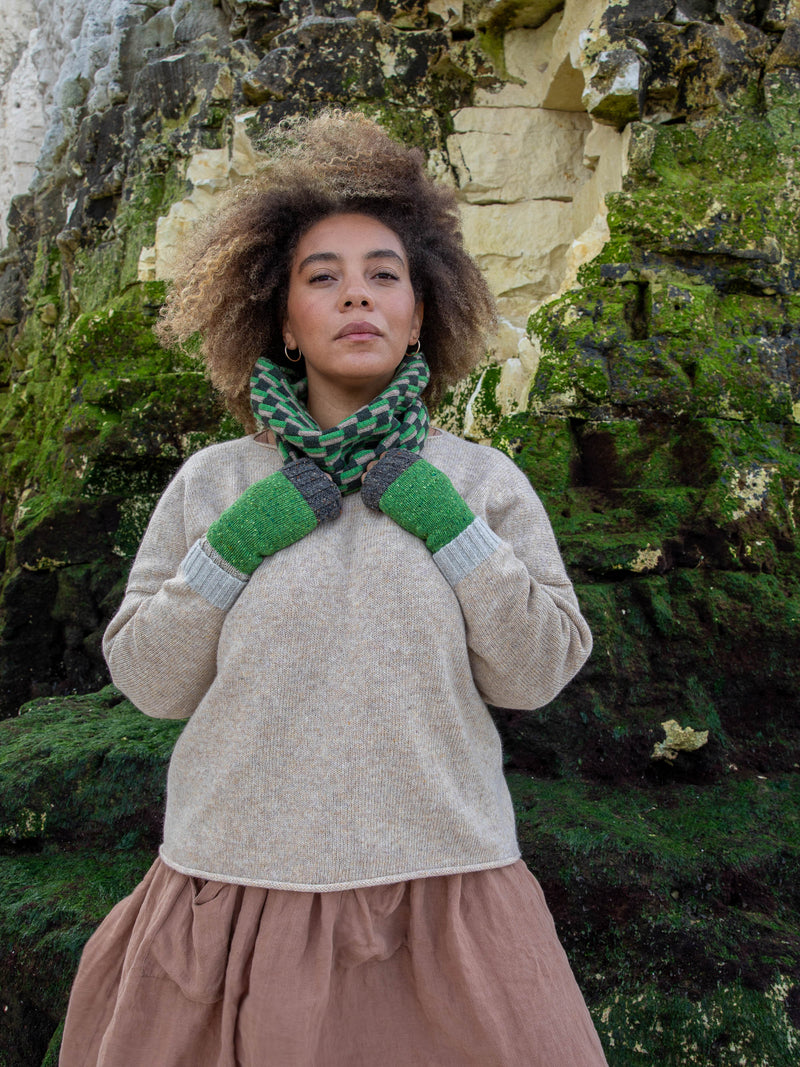 Model wears British Made Donegal Wool Wrist Warmers for Women in Leaf Green, Grey and Natural and Green Chequerboard Wool Snood