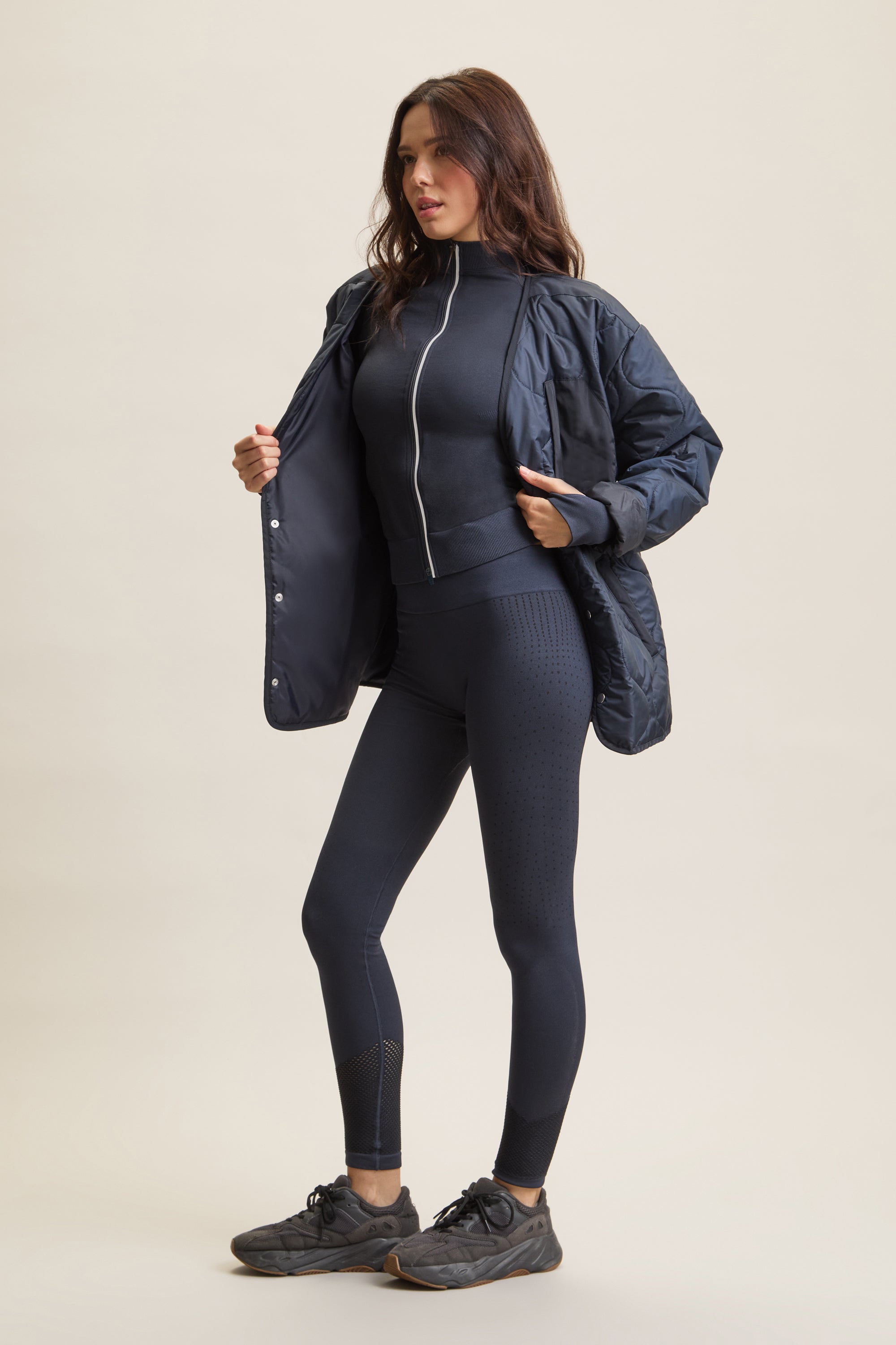 Women's contour sculpting zip-thru jacket with a fitted design for a sleek, flattering silhouette. Lightweight activewear zip-up with 3M reflective piping for visibility, a double-ended zipper for customizable styling, and thumbhole cuffs for a secure fit. Ideal for layering over activewear sets, gym workouts, running, yoga, and athleisure fashion. High-performance sculpting jacket for comfort, mobility, and effortless street style.