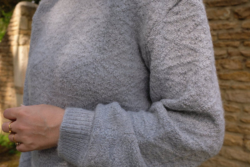 Close up of the Cloud Stitch Jumper in grey showcasing its soft texture, perfect for sustainable knitwear jumper lovers.