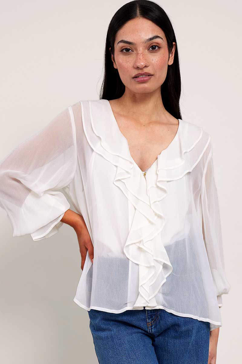 Model wears East Heritage Nuan White ruffle neck blouse.