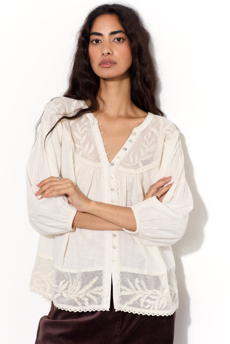 Model wears EAST Theia Ivory Embroidered Mesh Top