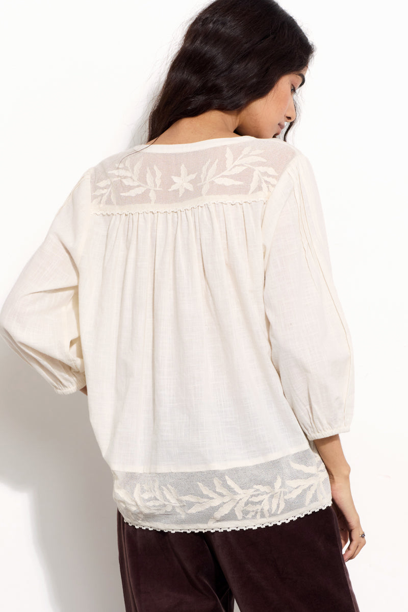 Model wears EAST Theia Ivory Embroidered Mesh Top