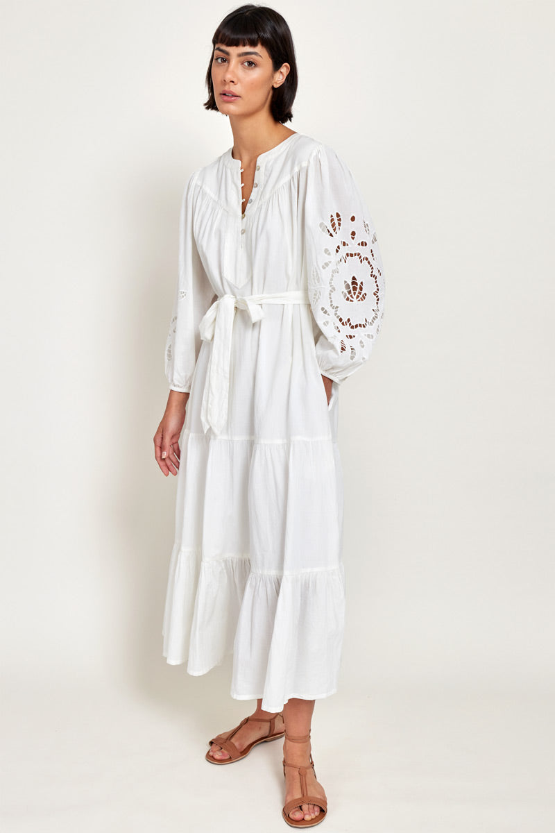 Model wears East Heritage Bridget White Organic Cotton Embroidered Dress, hand in pocket