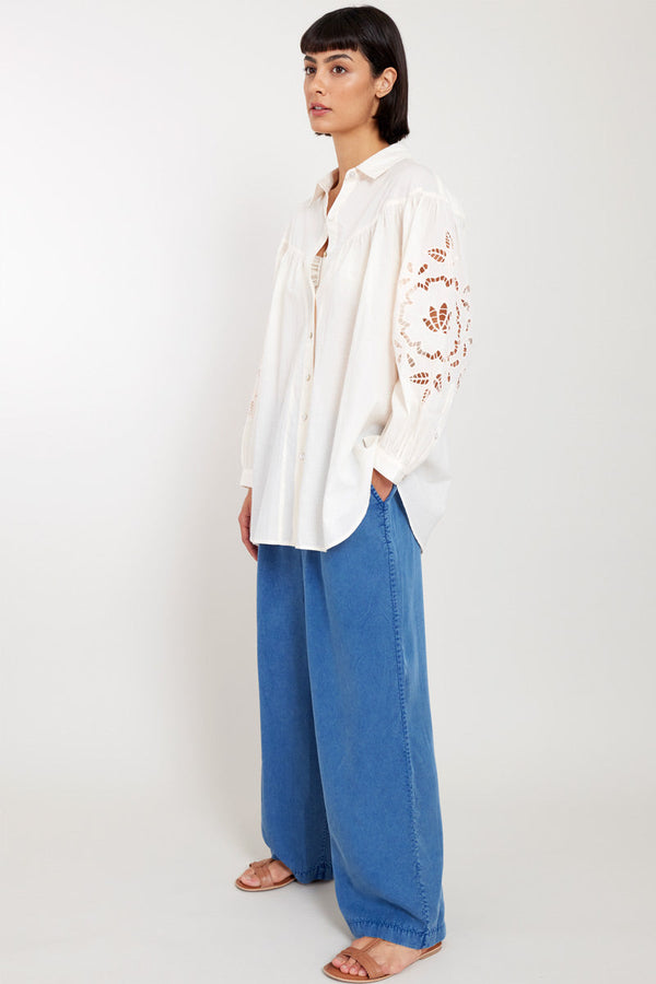 Model wears East Heritage Bridget Soft Peach Organic Cotton Shirt with the East Heritage Tessa Trousers