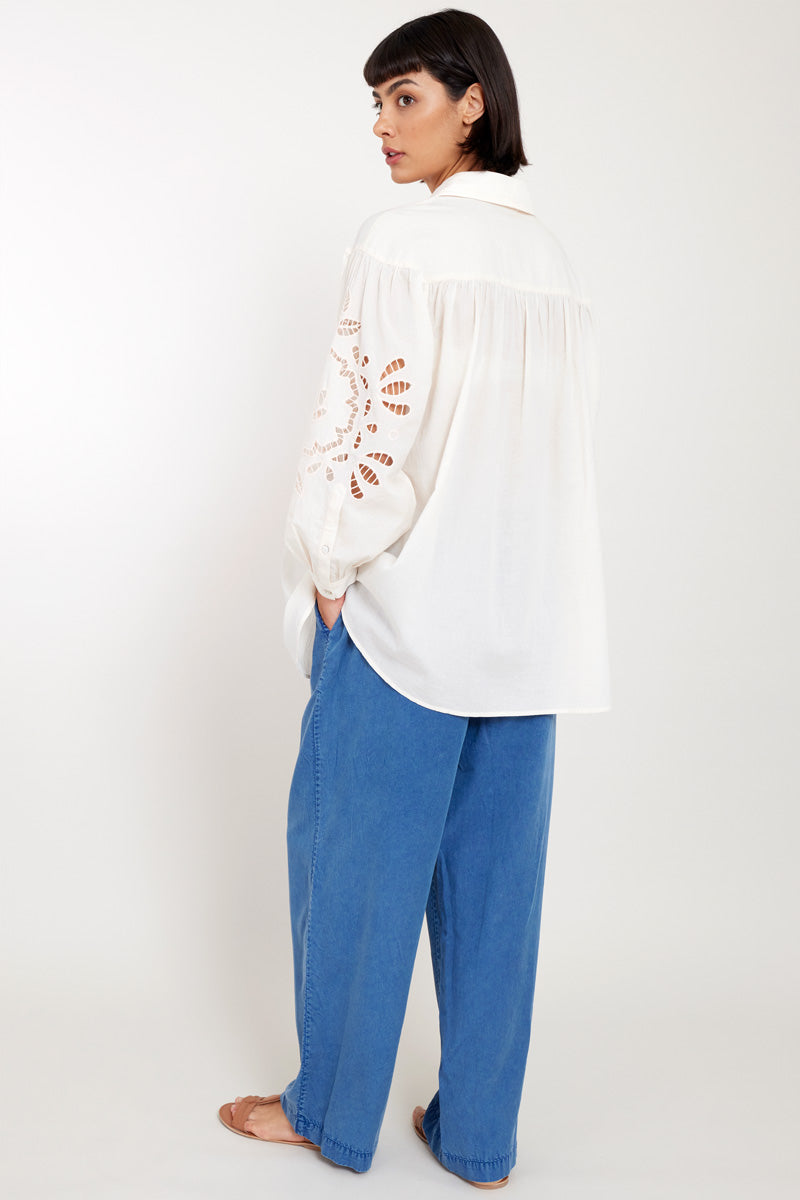 Back view of model wearing Bridget Soft Peach Organic Cotton Shirt with East Heritage Tessa Trousers
