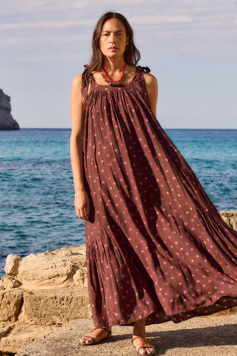 Full length of model wearing East Paola Spot Sleeveless Dress by the sea
