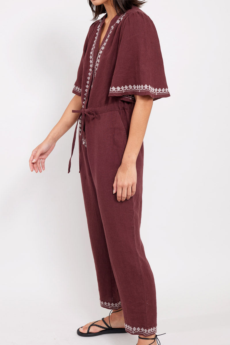 Side view of model wearing East Vivi Embroidered Jumpsuit