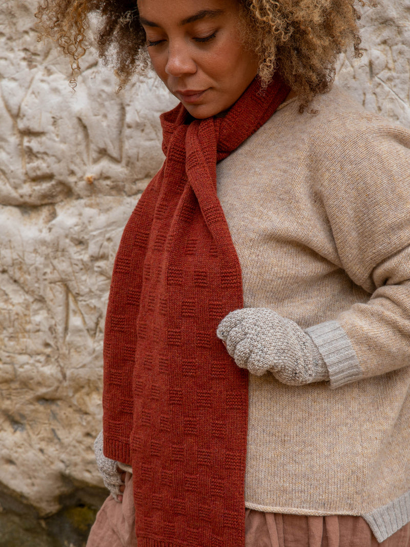 Model wears British Made Unisex 100% Merino Wool Unisex Garter Sitch Scarf in Rust and Fingerless Gloves in Natural