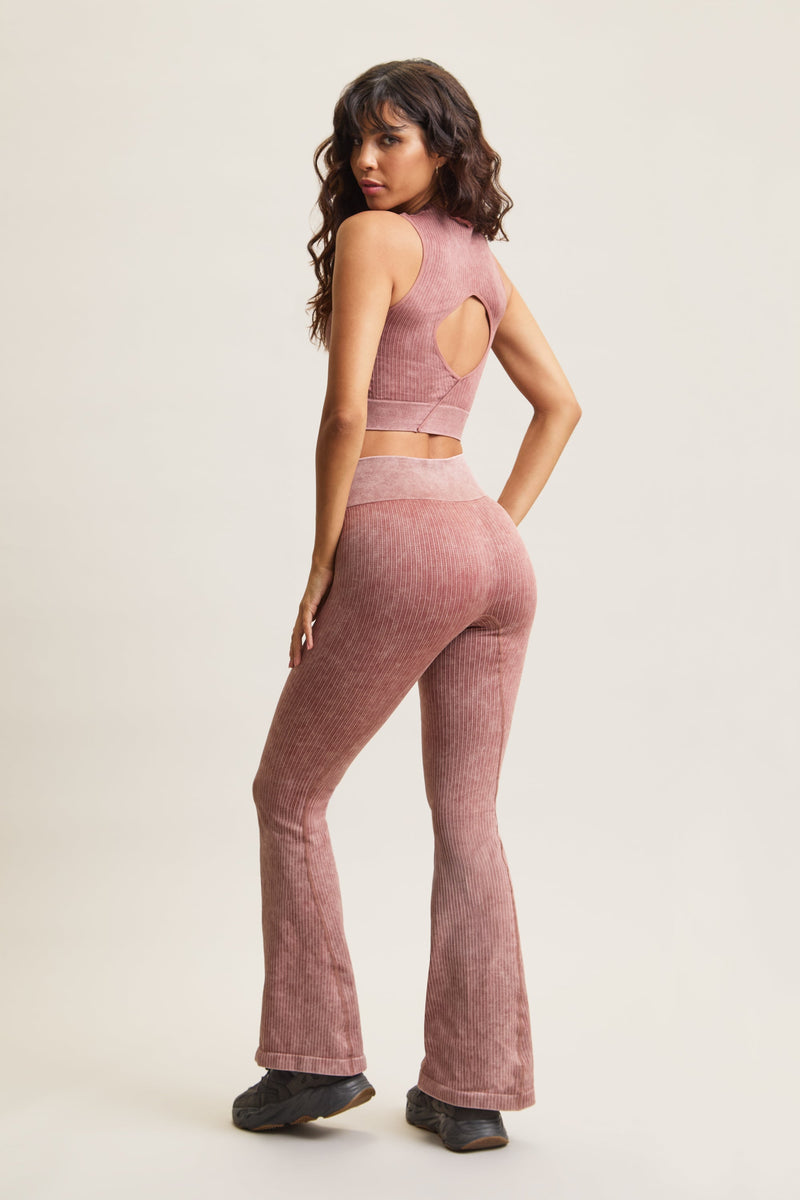 Women's HRMN8 pink orange Takeover Ribbed Cropped Top with an acid wash finish, featuring rib pin detailing, a seamless design, and a stylish cut-out back. Lettuce edge neckline adds a soft, feminine touch. Designed for athleisure, casual wear, and effortless styling. Pairs with the Takeover Flare Ribbed Leggings for a coordinated set.