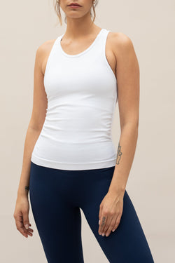 White seamless recycled moisture wicking sleeveless tank top with side ruching for yoga, pilates, gym, cycling, running and exercise by sustainable activewear brand Jilla Active