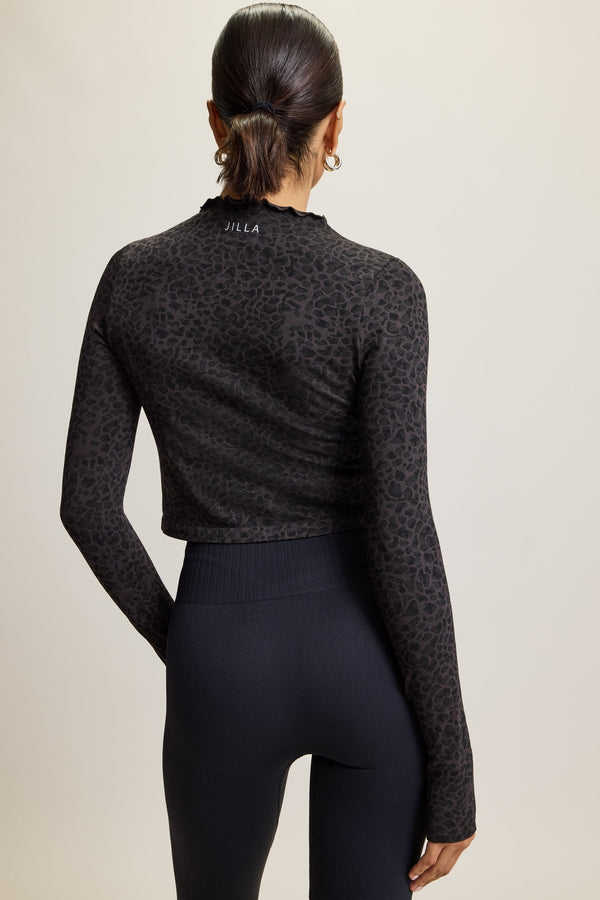 Stretchy activewear top made from recycled fabric, featuring thumbholes for added warmth, breathable material for comfort during workouts, and stylish neck detailing. Perfect for gym sessions, yoga, lounging, or casual wear, and part of a matching set with coordinating leggings and bra.