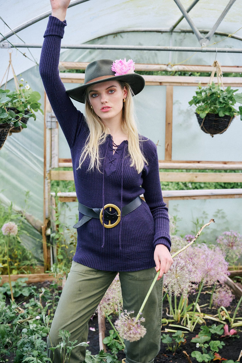 A blonde lady in a Herd fitted navy top made from sheep wool