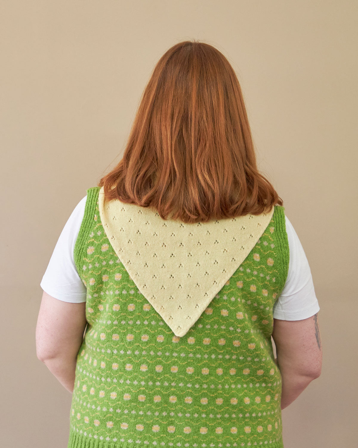 Model wearing pale yellow lace neck scarf knitted in soft lambswool. designed and made in the UK by Rove.