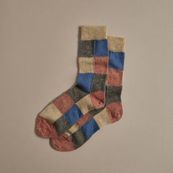 Patchwork marino wool socks in blue, red, natural and grey.