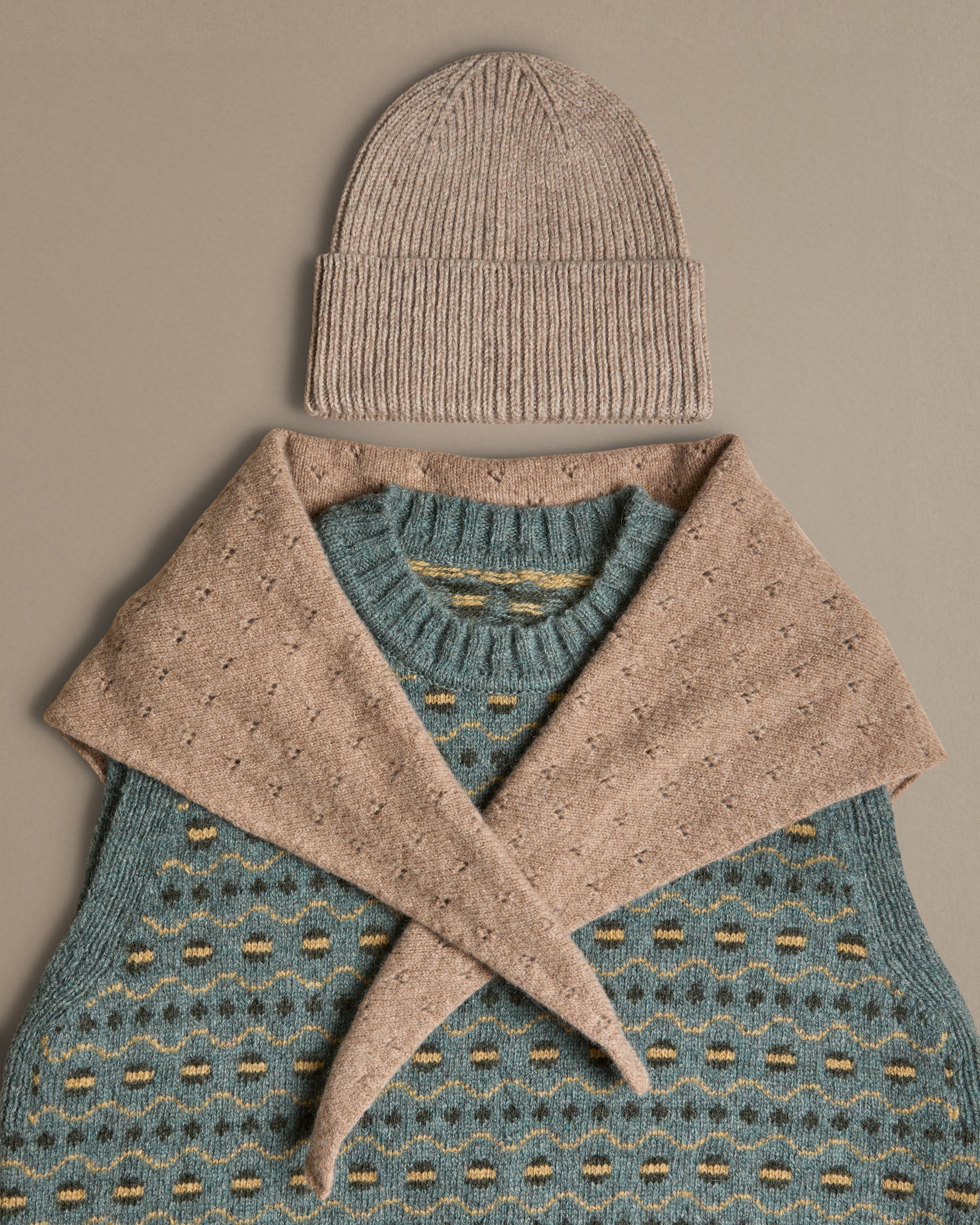 Fair isle blue vest, knitted in Scottish spun wool. Designed and made in Britain.  Worn with hat and neckerchief. 