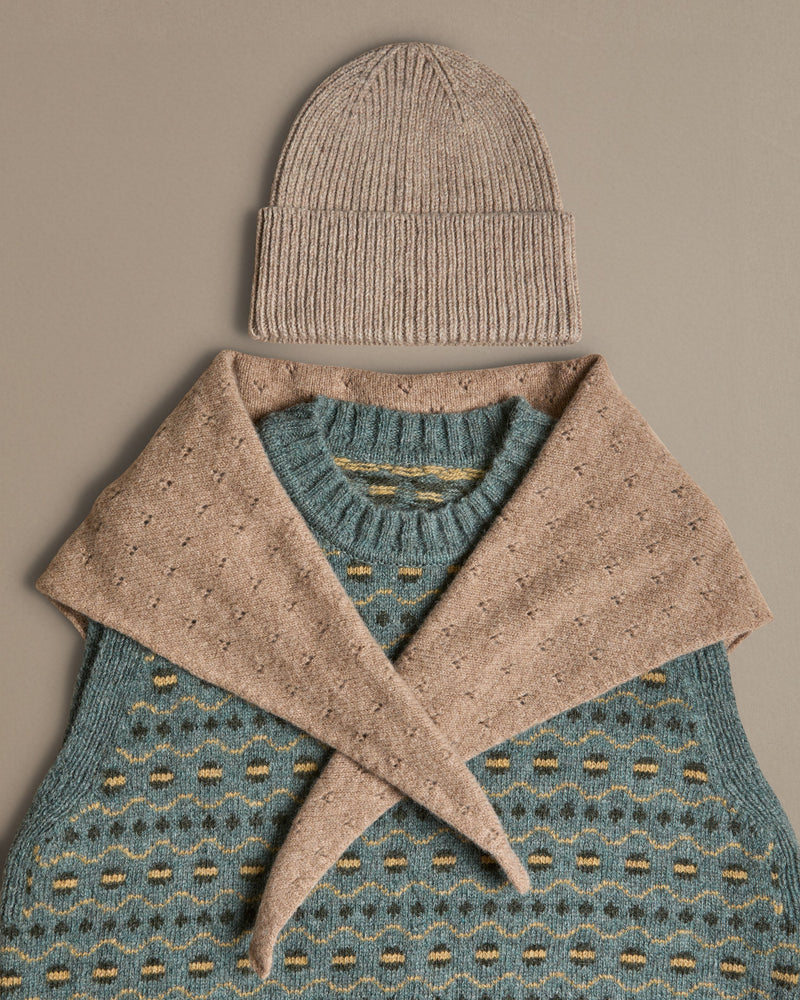 Fair isle blue vest, knitted in Scottish spun wool. Designed and made in Britain.  Worn with hat and neckerchief. 
