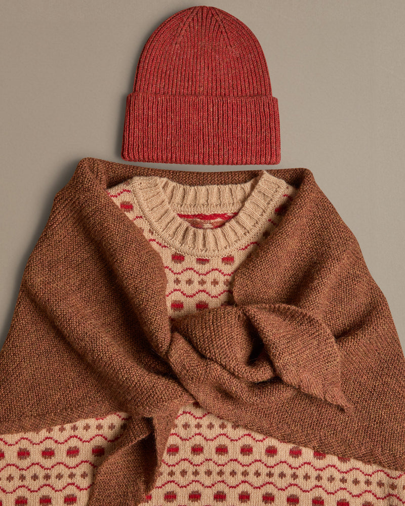 A beige and red Fair Isle vest, knitted in Scottish spun wool. Worn with hat and neckerchief. Designed and made in the UK. 