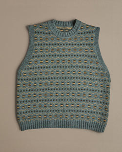 A blue vest with a Fair Isle pattern. Knitted in Scottish spun wool, designed and made in the UK. 
