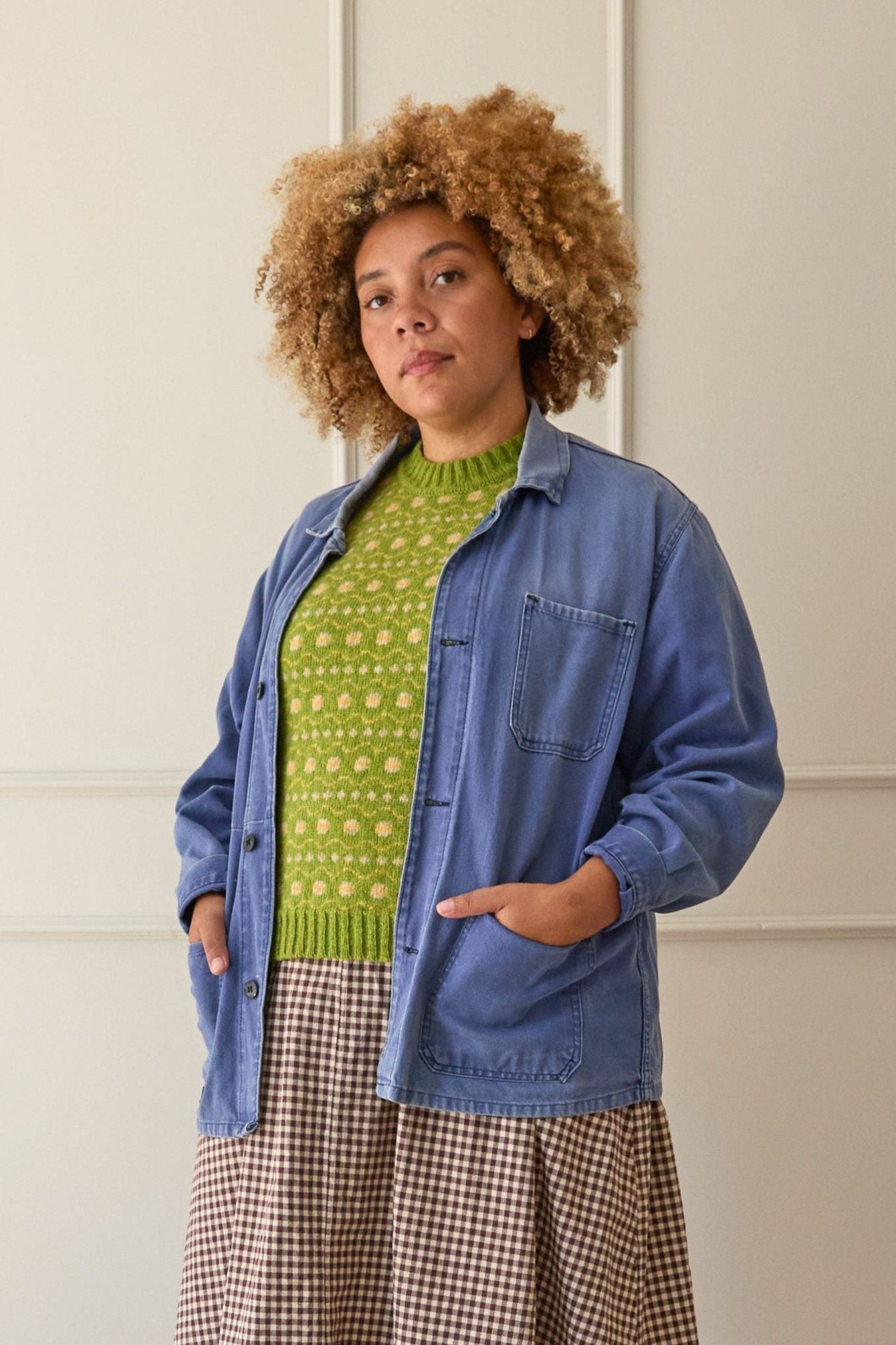 Model wears a lime green fair isle vest. knitted in Scottish spun wool. Designed and made in the UK.