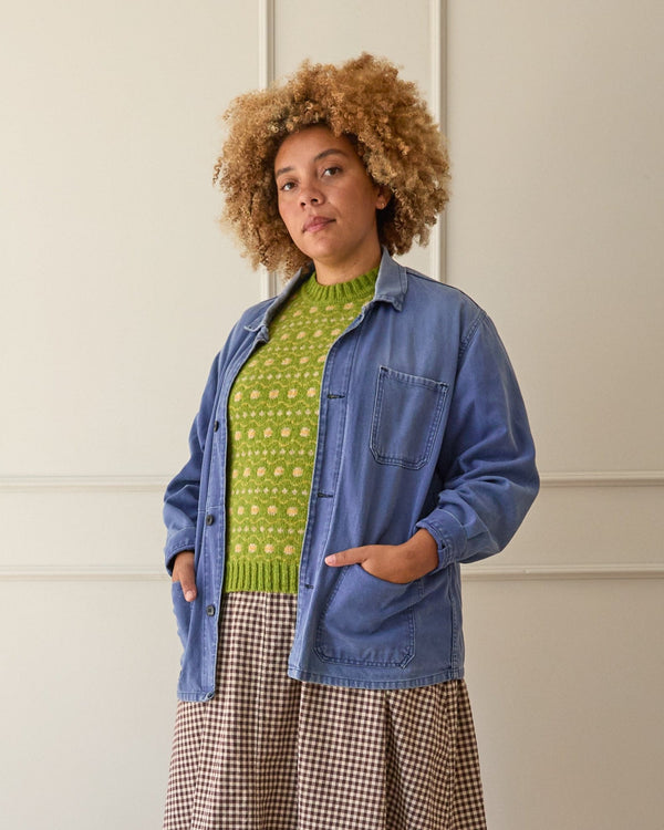Model wears a lime green fair isle vest. knitted in Scottish spun wool. Designed and made in the UK.