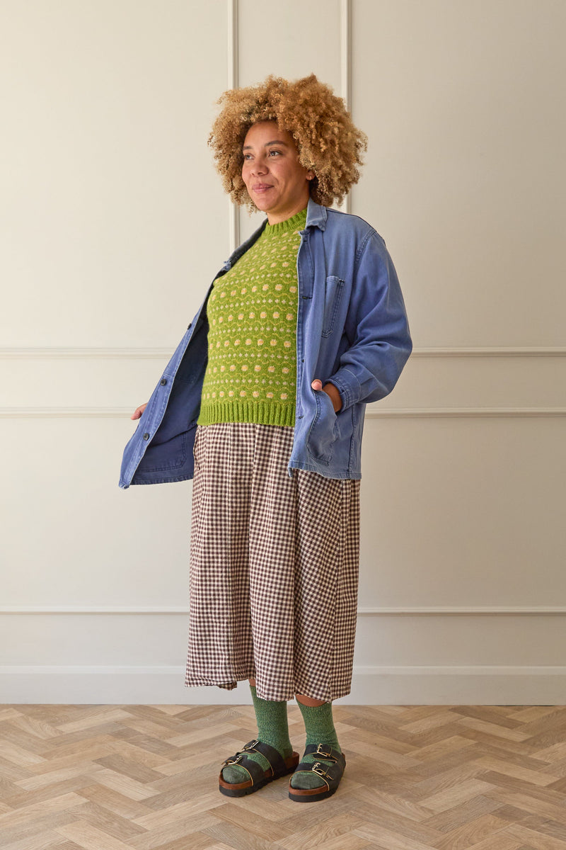 Model wears a lime green and yellow fair isle vest. Knitted in Scottish spun wool. Designed and made in Britain.