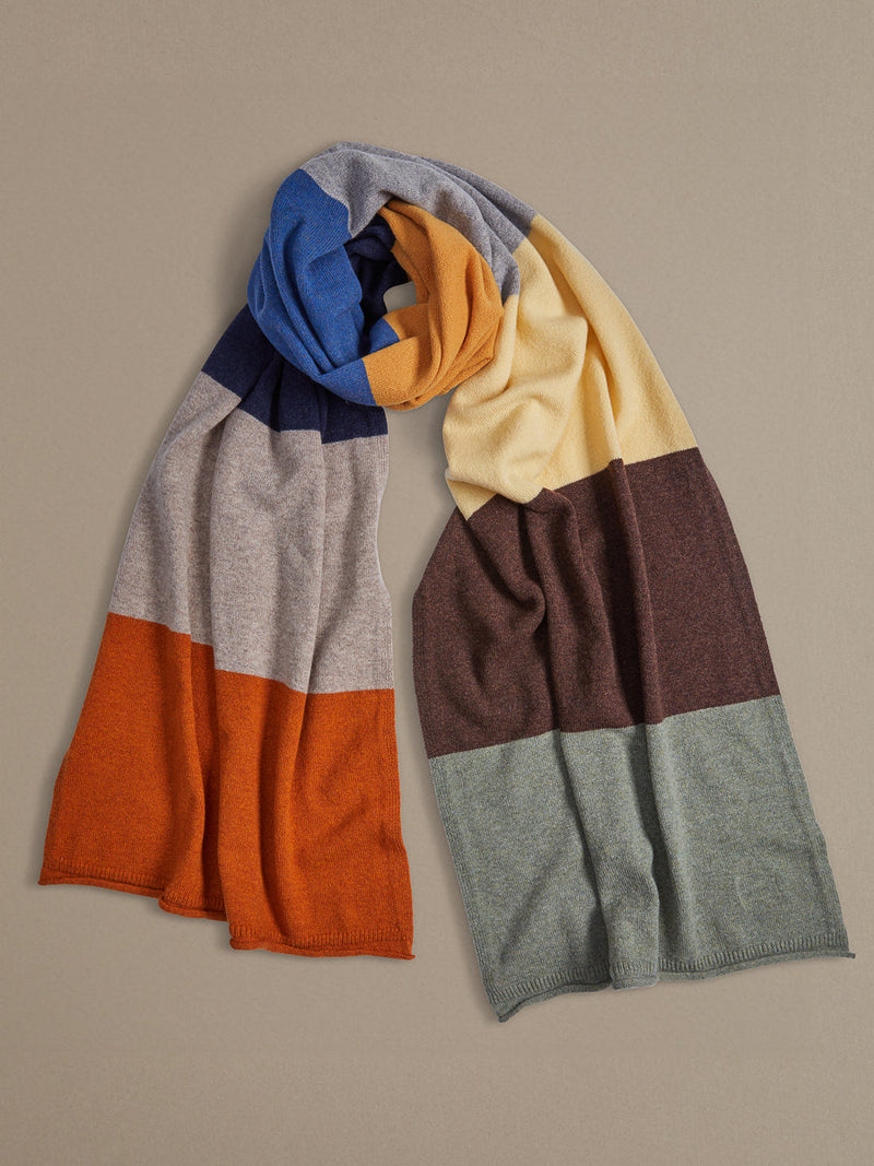 Over-sized multi stripe Light Brown, Oxide Orange, Charcoal, Ocean Blue, Harvest Yellow, Navy Blue, Kelp Green, Ecru, Light Green, and Rust Red. Merino Wool. 