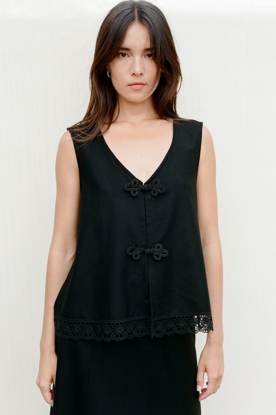 The Marie Sleeveless Wool Vest in black with lace trim