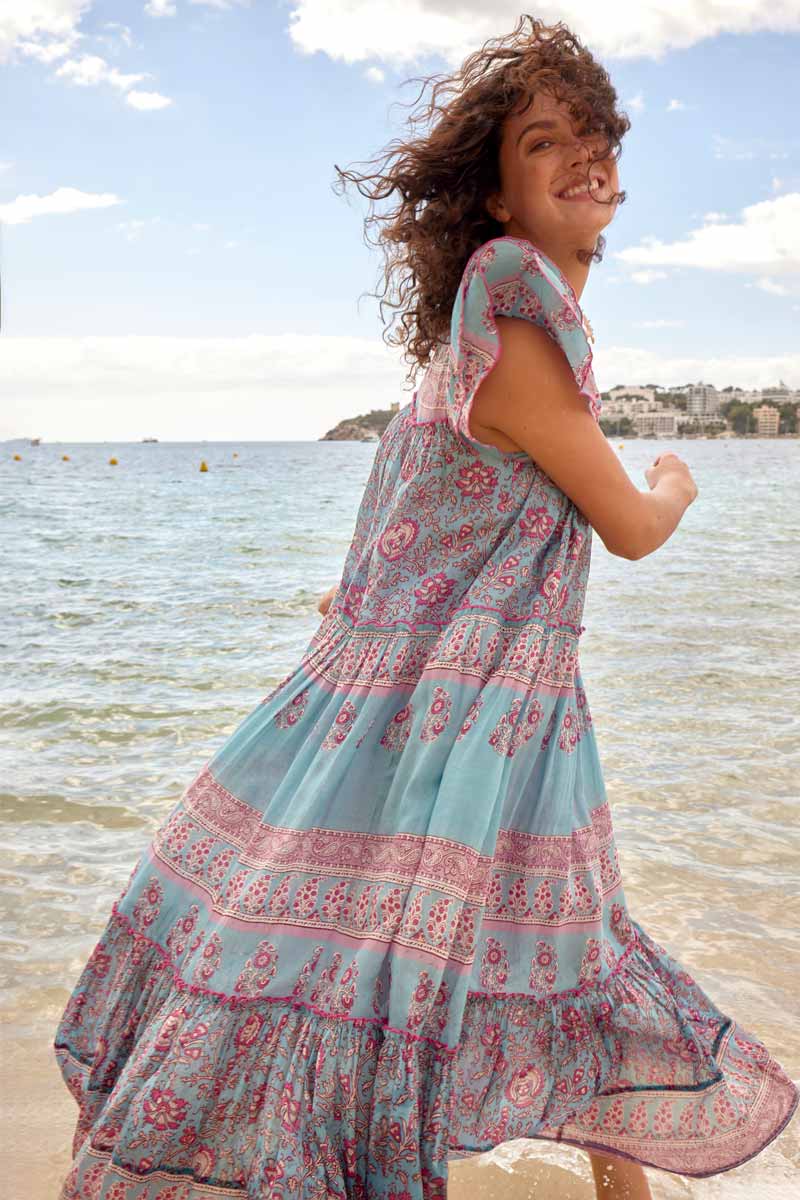 Model wears Souki Dress, side view running in the water