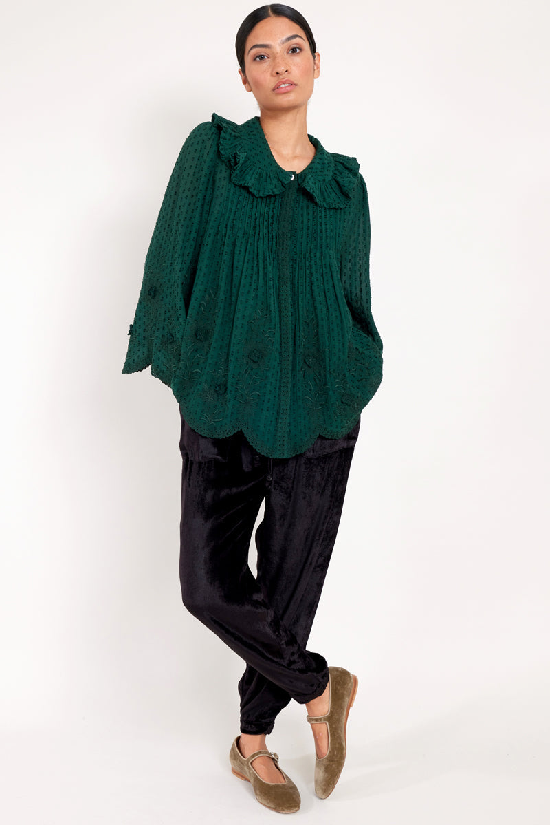 Model wears green embroidered cotton viscose blouse by east.co.uk