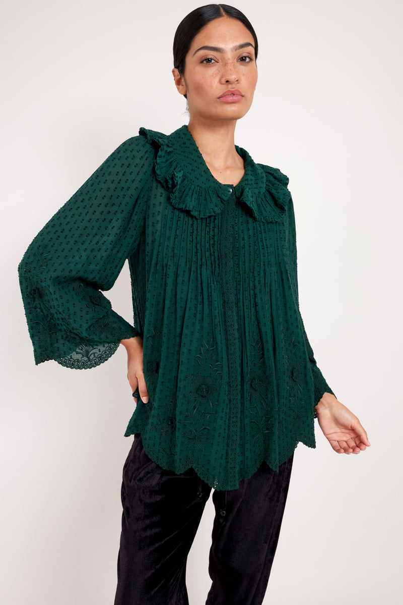 Model wears green embroidered cotton viscose blouse by east.co.uk
