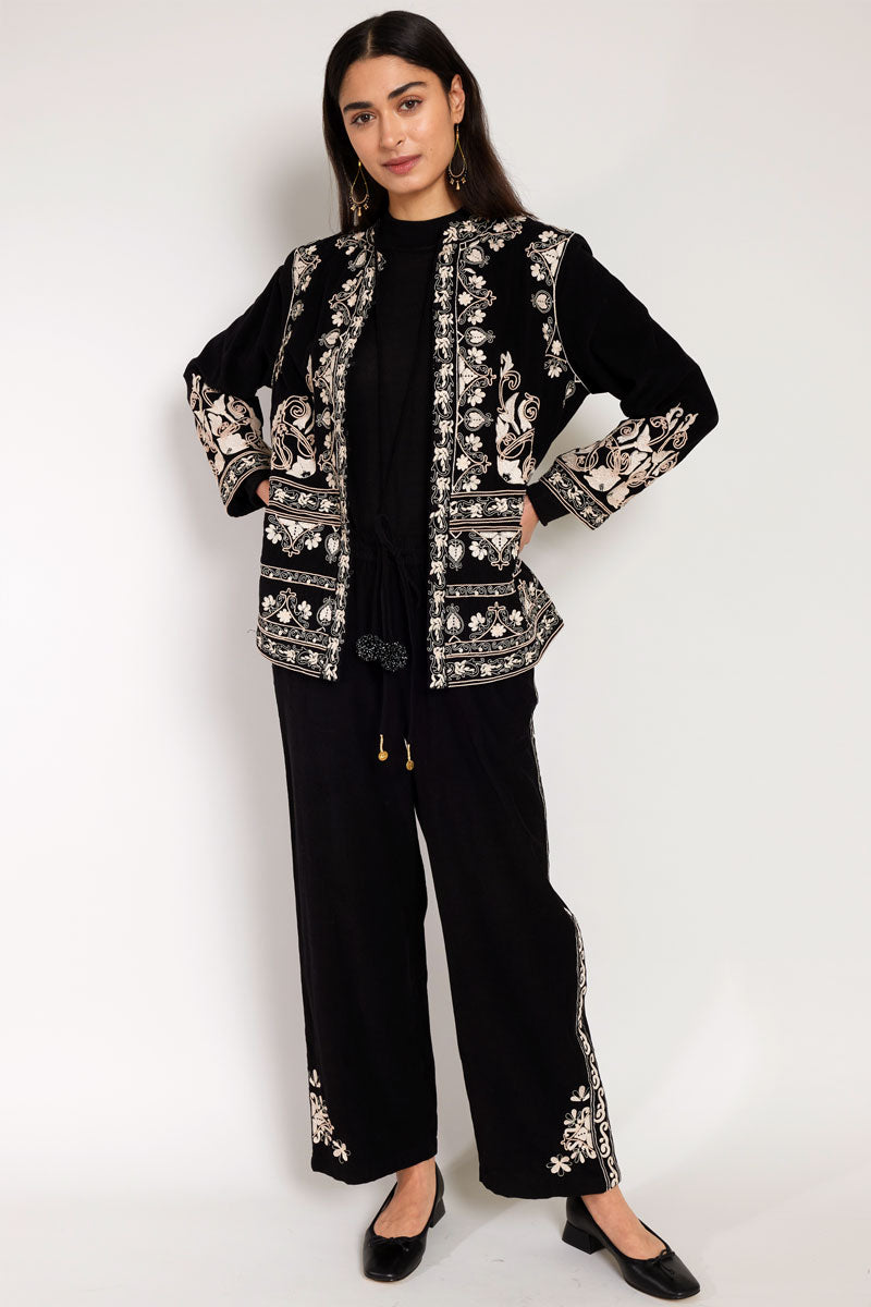 Front view of Model wearing East Eveline embroidered trousers, with East Eveline embroiderd Jacket 