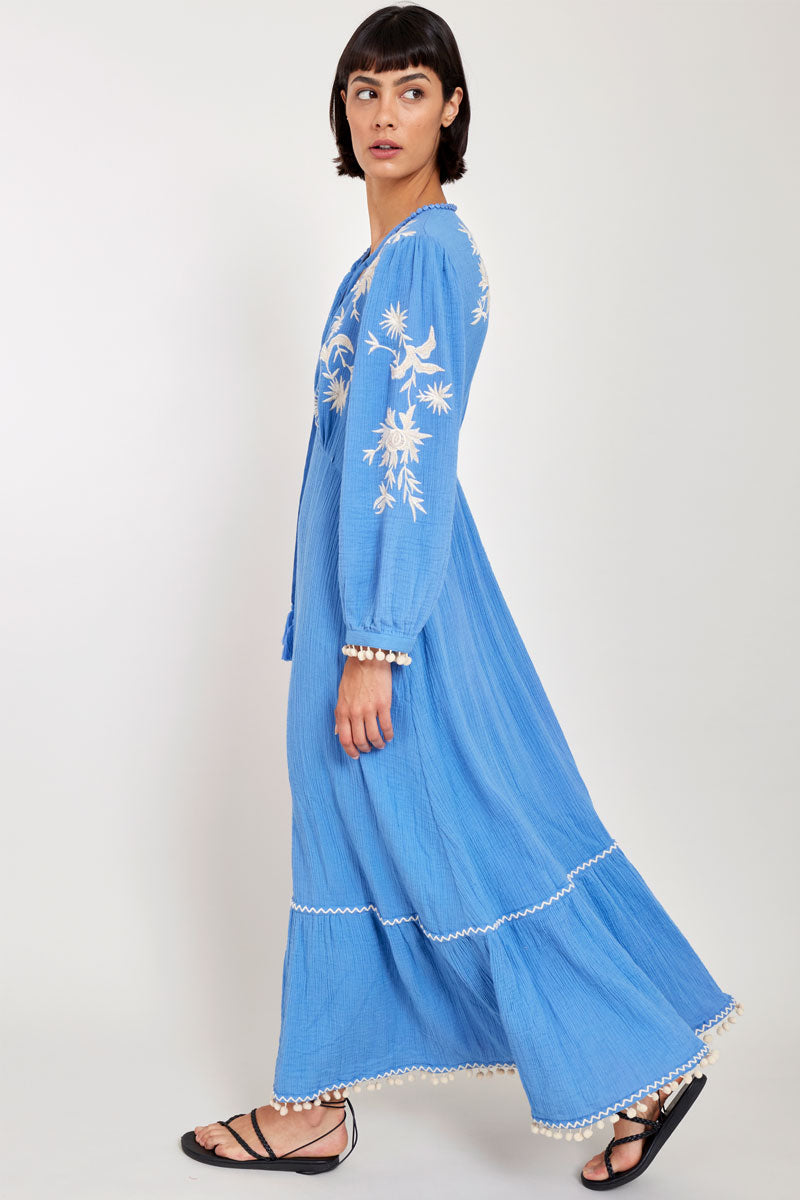 Side view of model wearing East Fern Embroidered Blue Cotton Gauze Dress