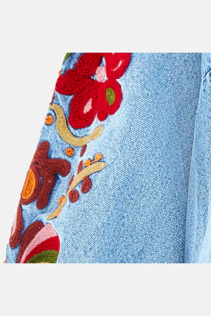Close up shot of embroidery on sleeve of East Feyre Denim Dress