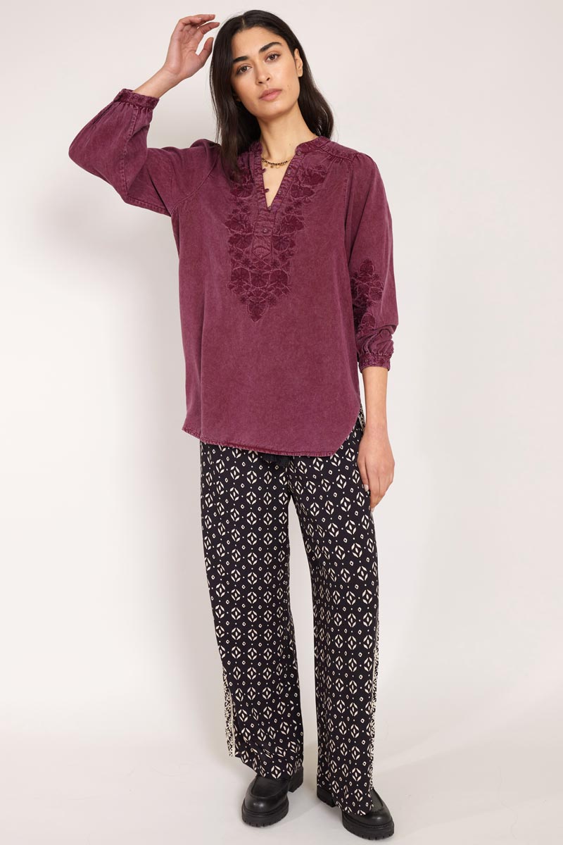 Front view of Model wearing East Kaia Trousers with embroidered blouse