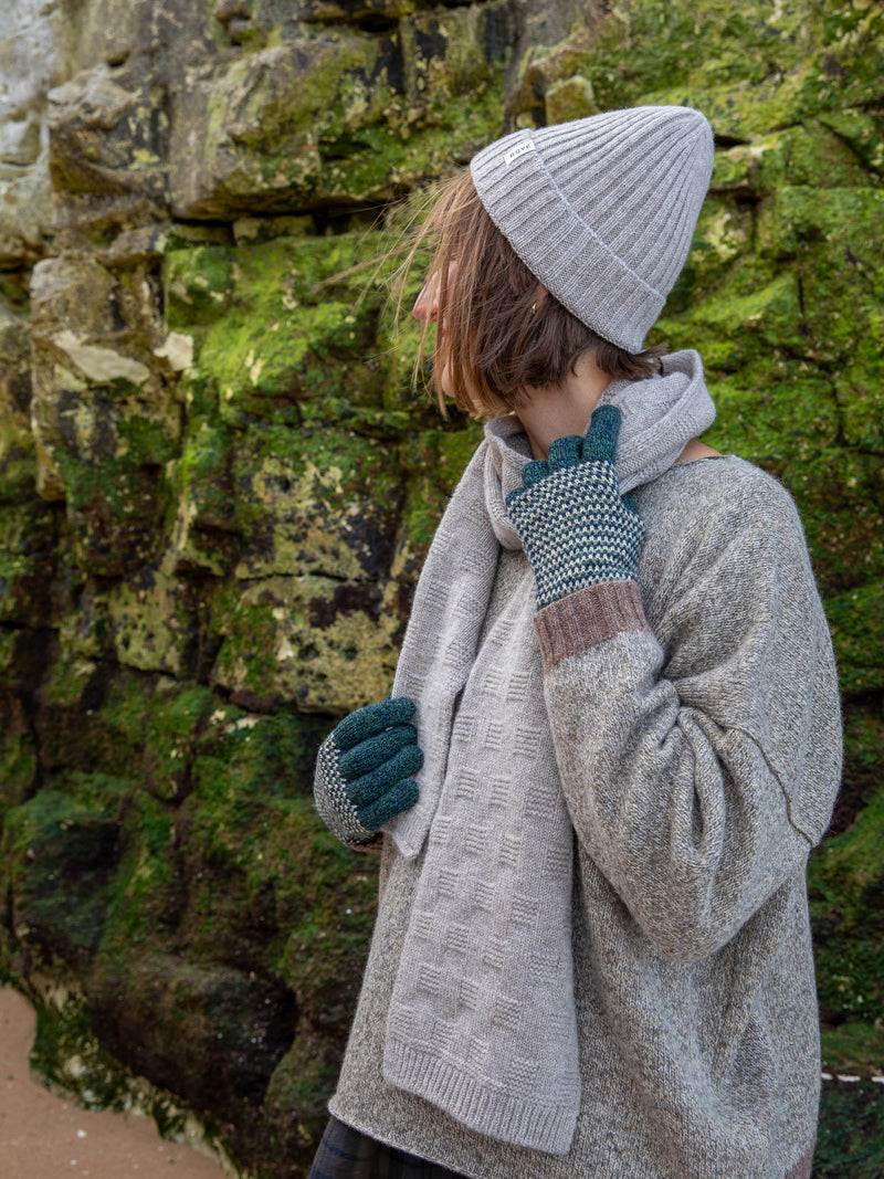 Model wears British Made Unisex Merino Wool Marl Gloves in Forest Green, the Garter Stitch Scarf in Grey and Grey Fishermans Beanie